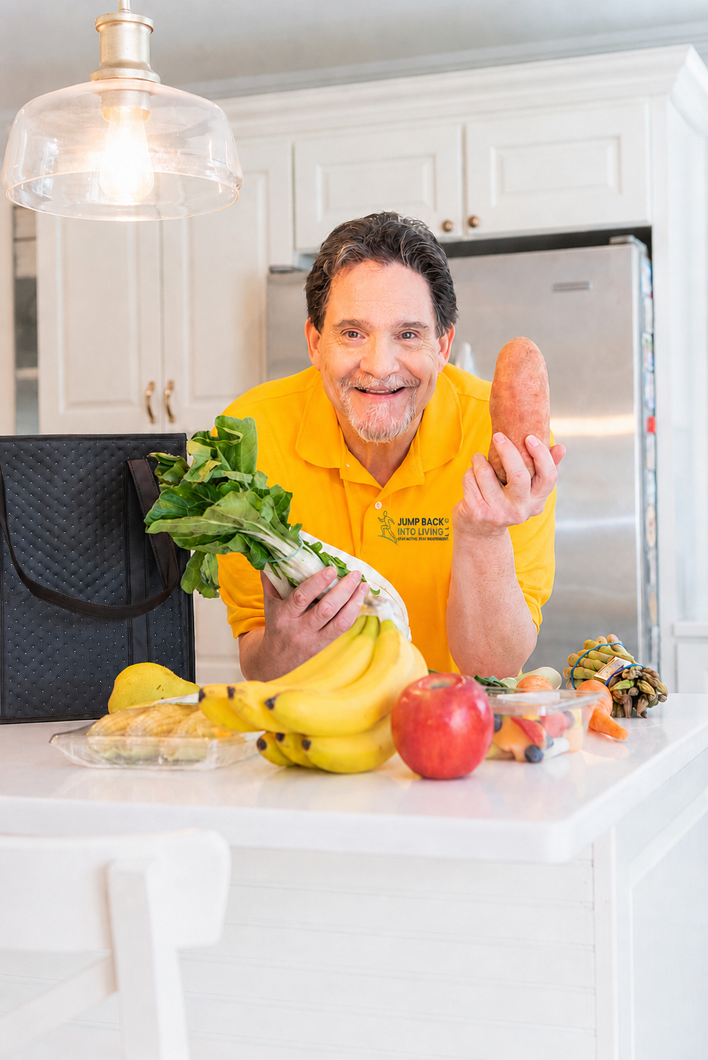 Bill Grant in a bright kitchen holding fresh vegetables, encouraging healthy, practical nutrition habits